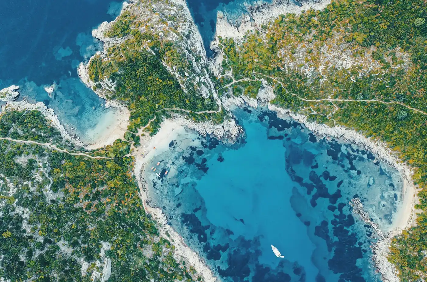 Aerial view of green headlands and deep blue water off Corfu